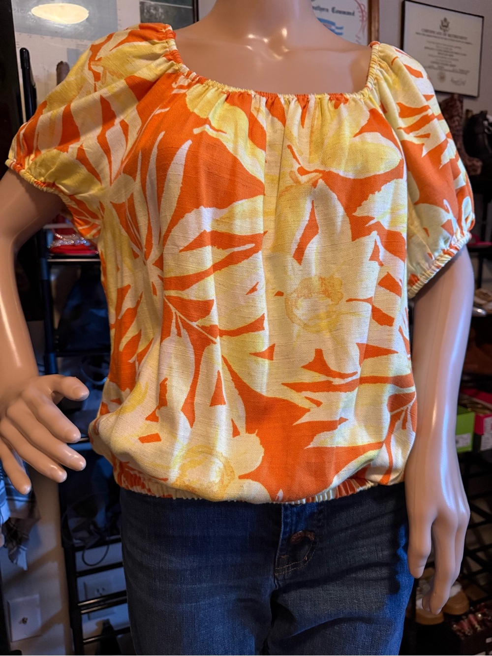 SINGLE THREAD Women’s Elastic-Hem Floral Peasant Top in Orange and Yellow.